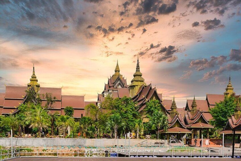 A traditional temple complex with multiple structures, surrounded by greenery and a body of water. 1