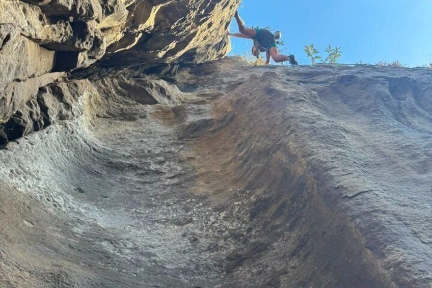 A person climbing a steep, rocky slope. 2