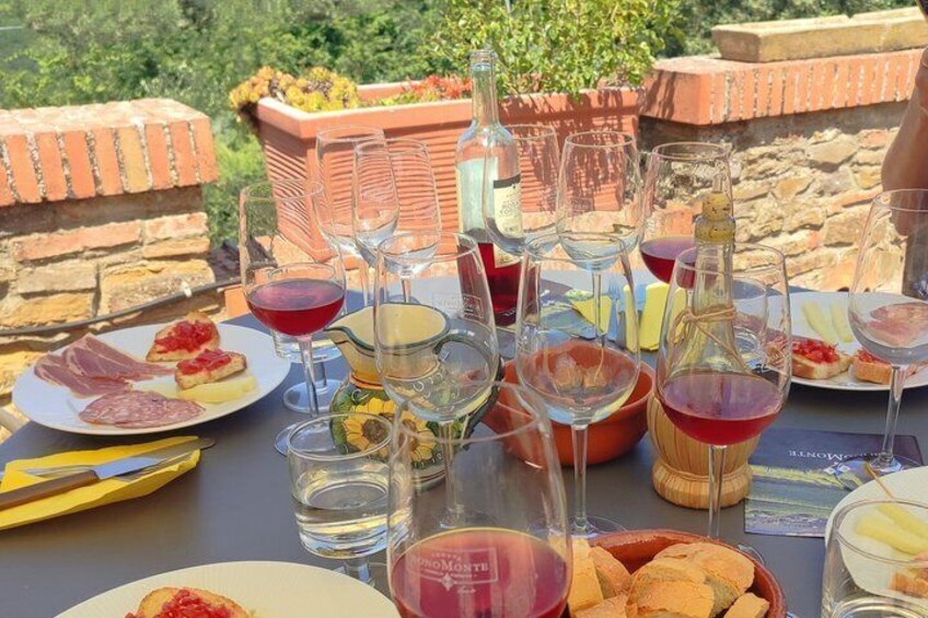 A table set for a meal with wine glasses, plates of food, and a bottle of wine. 5