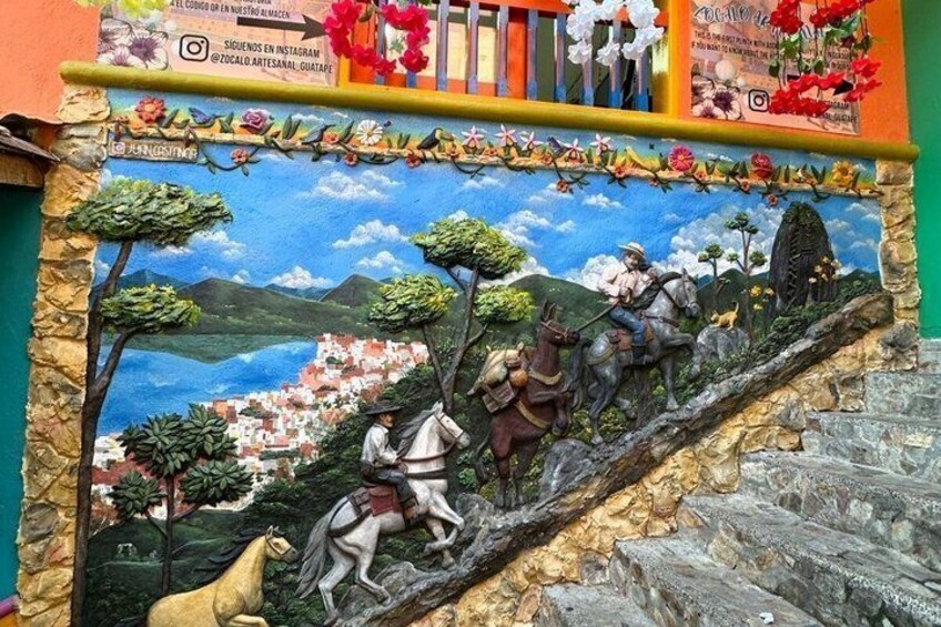 A mural with a landscape, a person on a horse, and a donkey. 3
