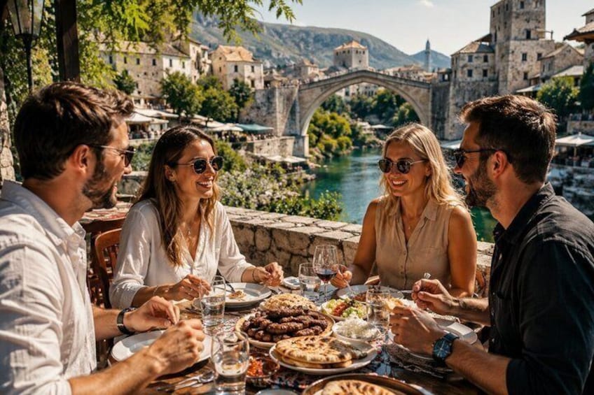 A group of people dining outdoors with a river and historic buildings in the background. 4