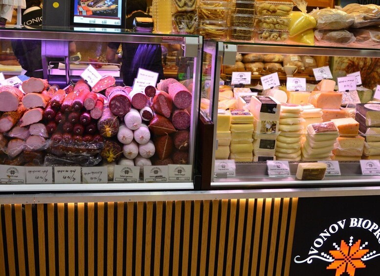 A deli display with various meats and cheeses. 3