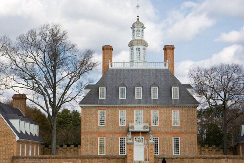 A large brick building with a prominent tower and a white door. 3
