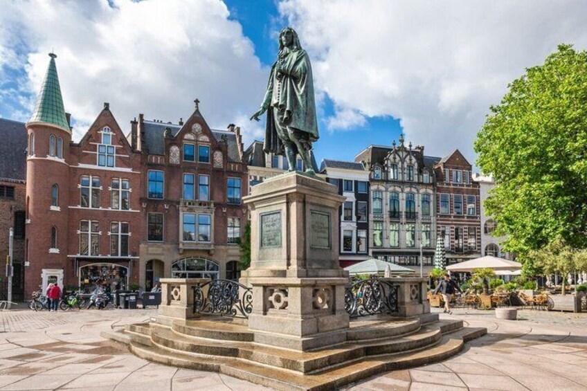 A statue in a square with historic buildings in the background. 5