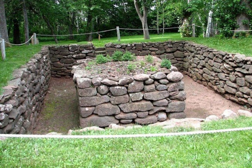 A stone structure with a grassy area in a park. 5