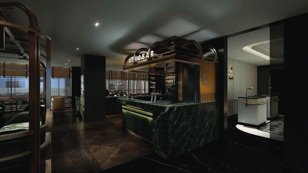 A modern bar area with a marble counter, wooden accents, and a sign that reads 'AERO BAR'. 1