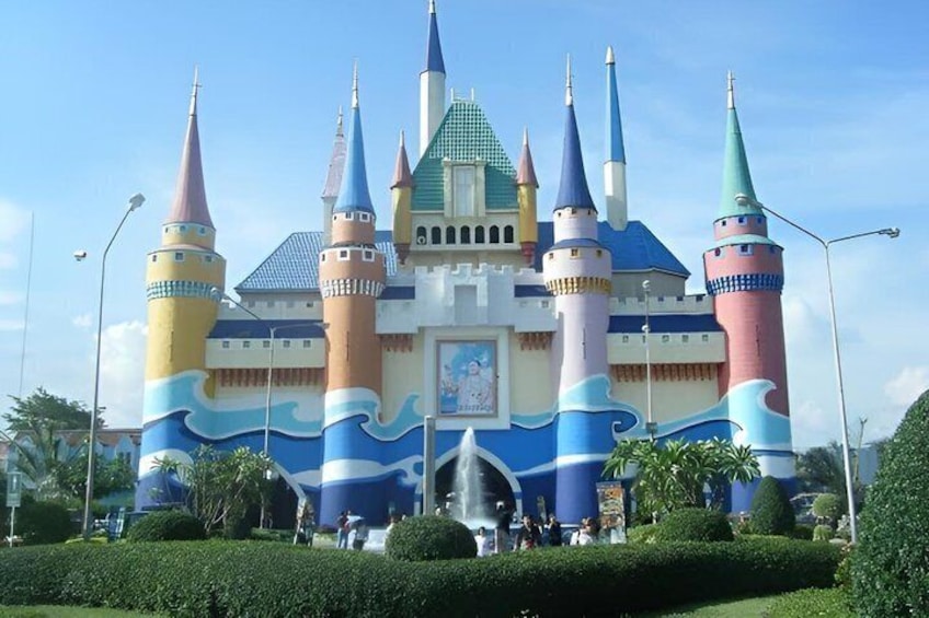 A colorful castle with multiple towers and a fountain in front. 5