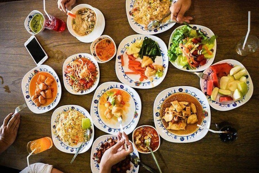 A table with various dishes, including salads, soups, and rice dishes. 3