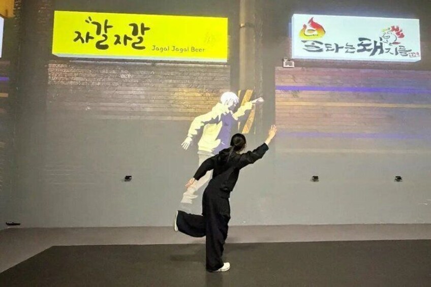 A person performing an action in front of a projection screen with text and logos. 3