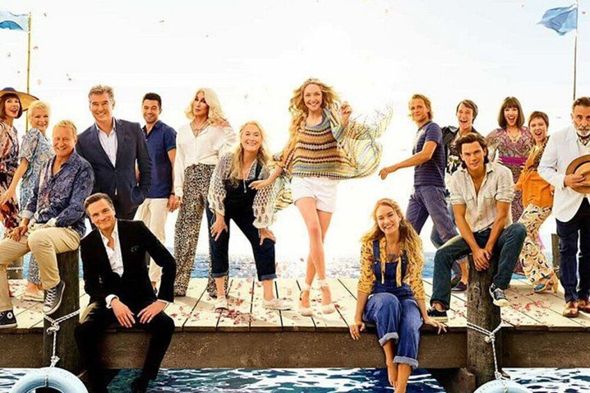 A group of people on a pier with water in the background. 3