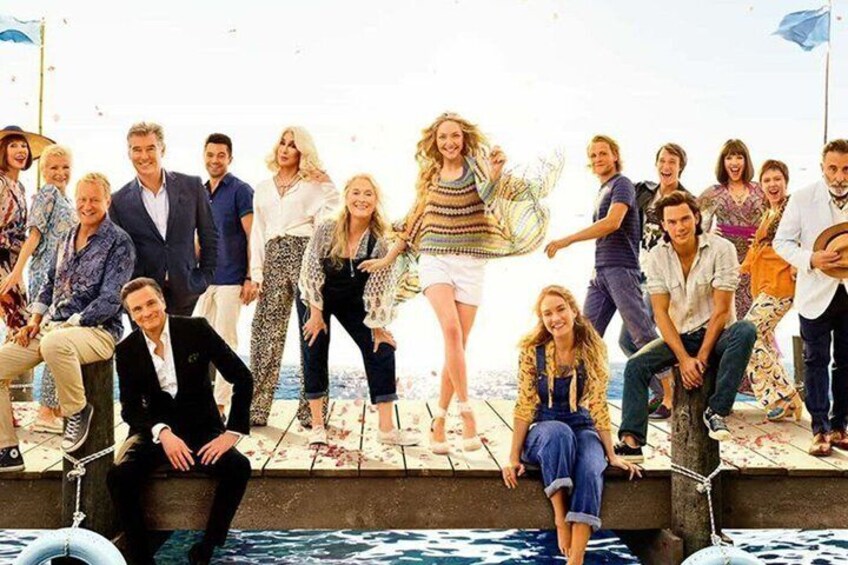 A group of people on a pier with water in the background. 3