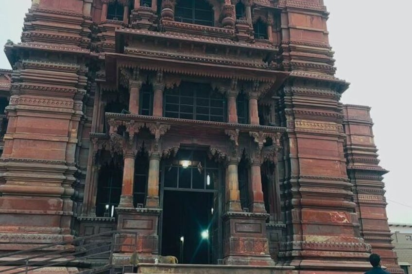 A large, ornate building with intricate carvings and columns. 1