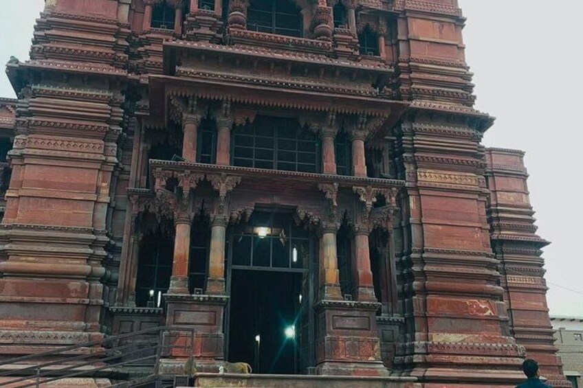 A large, ornate temple with intricate carvings and multiple tiers. 1