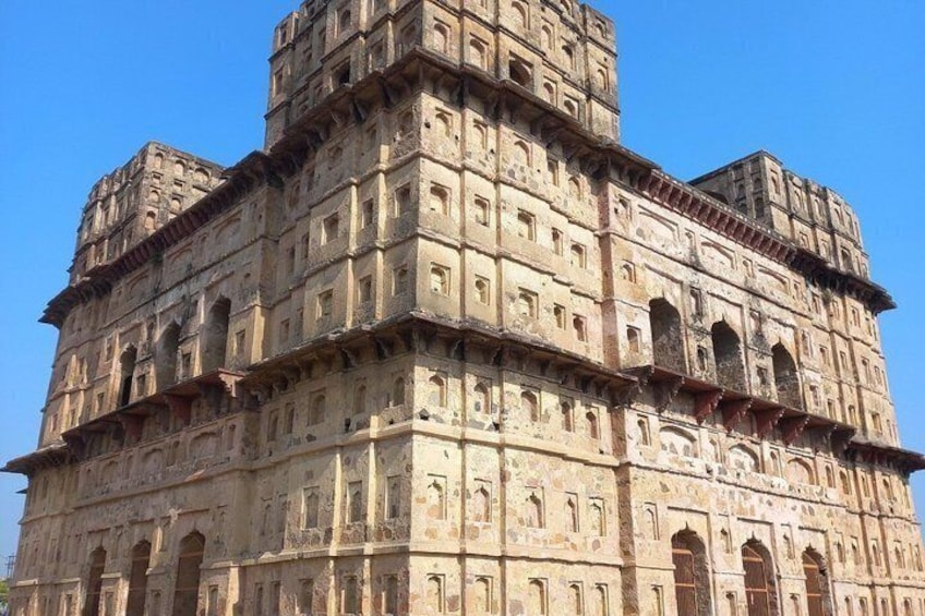 A multi-tiered historical building with intricate carvings and multiple levels. 4
