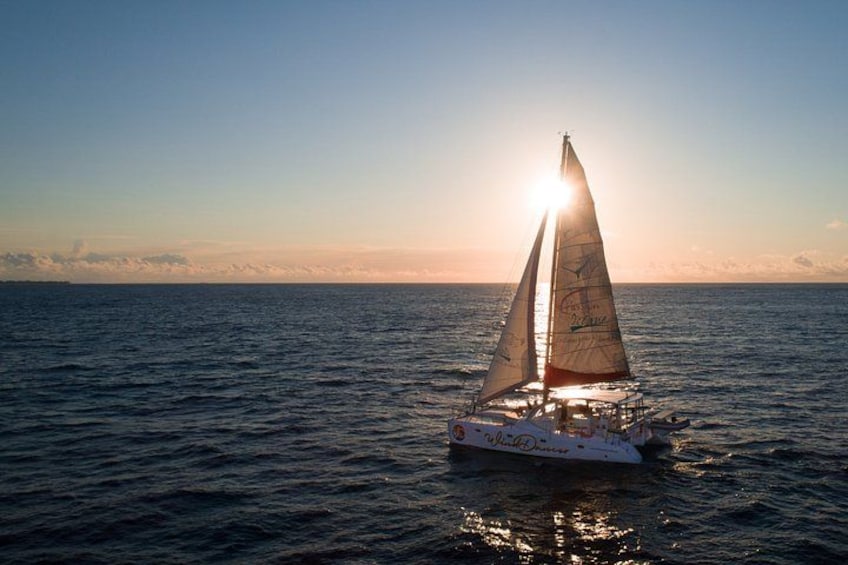 A sailboat on calm waters during sunset. 1