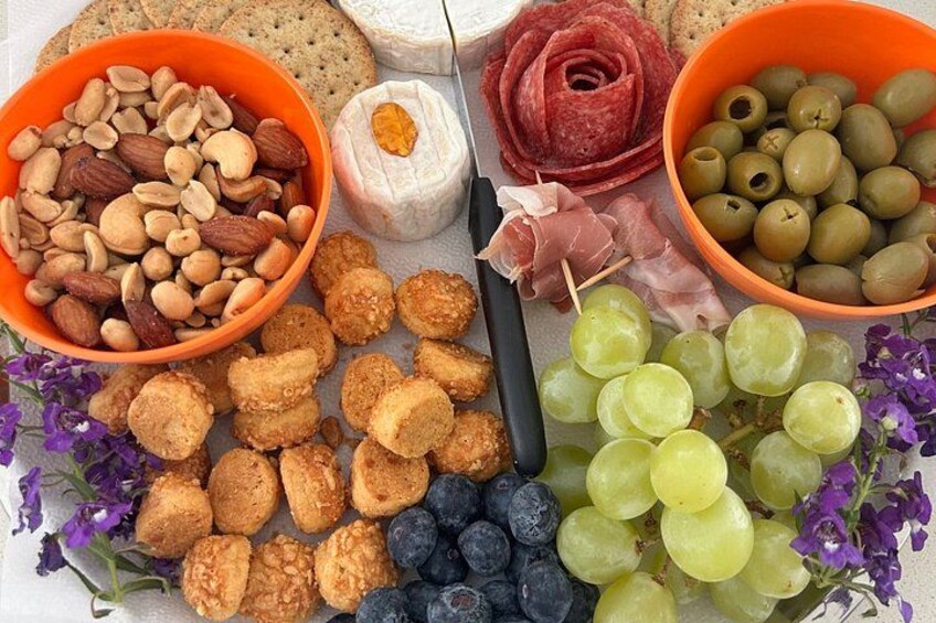 A variety of food items including almonds, cheese, grapes, and crackers. 2