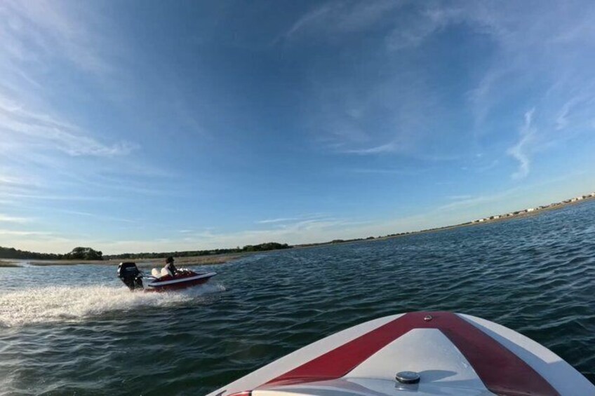 A speedboat on water with a clear sky. 1