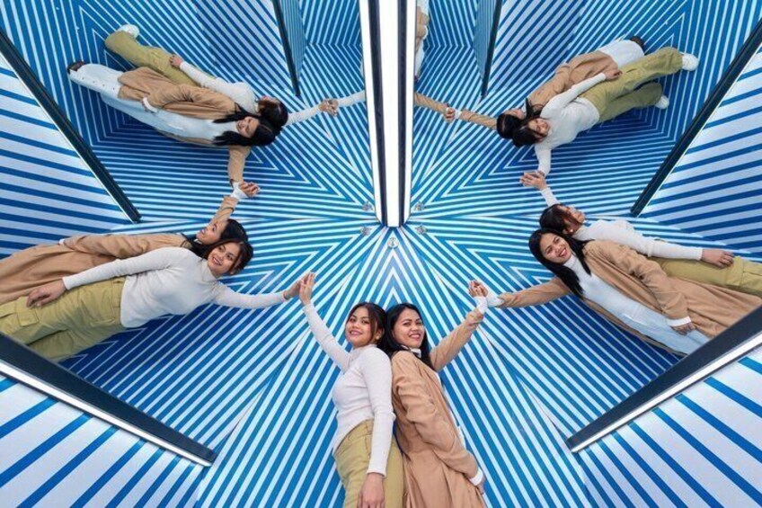 A mirrored geometric pattern with a central figure. 1