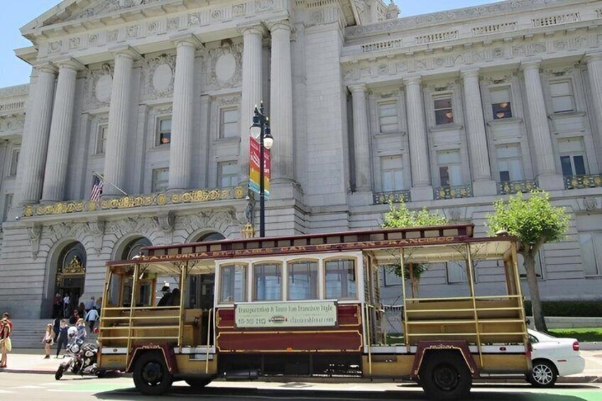 A vintage trolley in front of a large classical building with columns. 2
