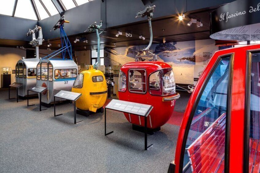 A museum exhibit with vintage cable cars numbered 37, 38, and 39. 2