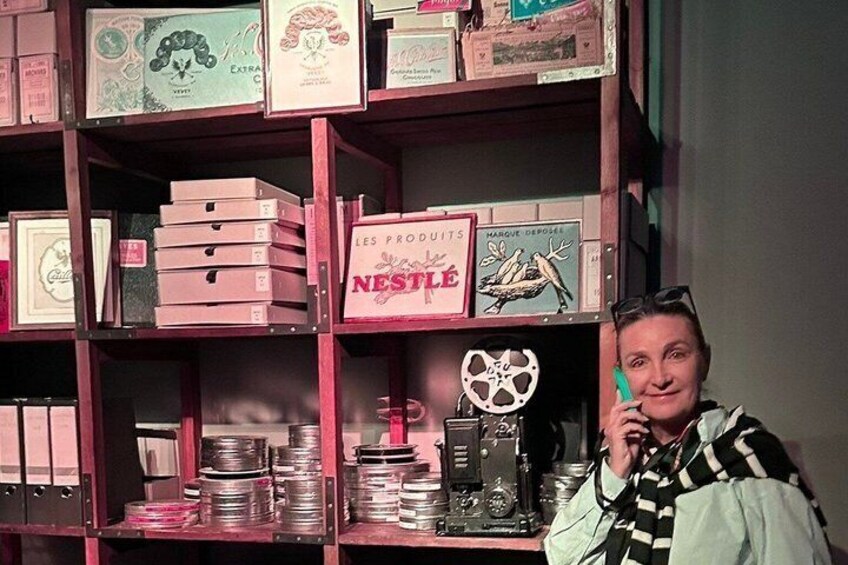 A person in front of a shelf with various boxes, including a prominent Nestle box. 4