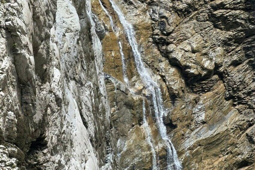 A waterfall cascading down a rocky cliff. 5