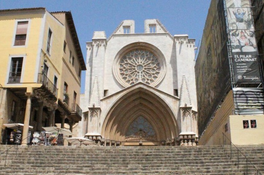 A historic cathedral with a large rose window and a bell tower. 3
