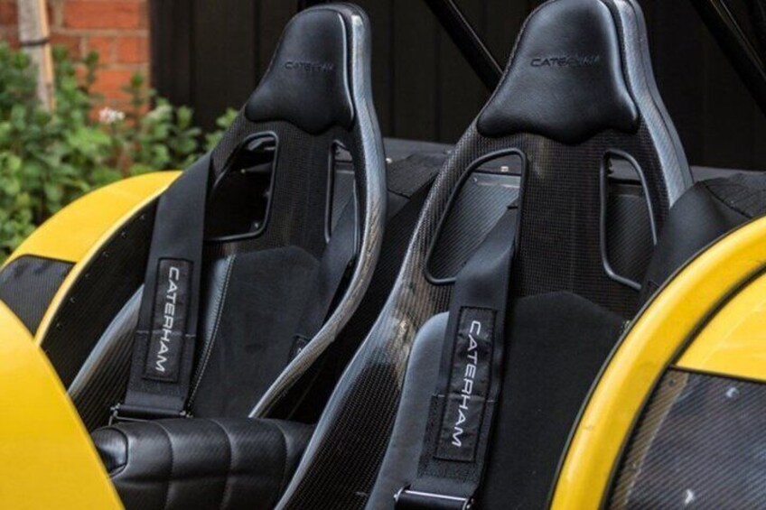 A row of black racing seats with 'CATERHAM' branding. 4