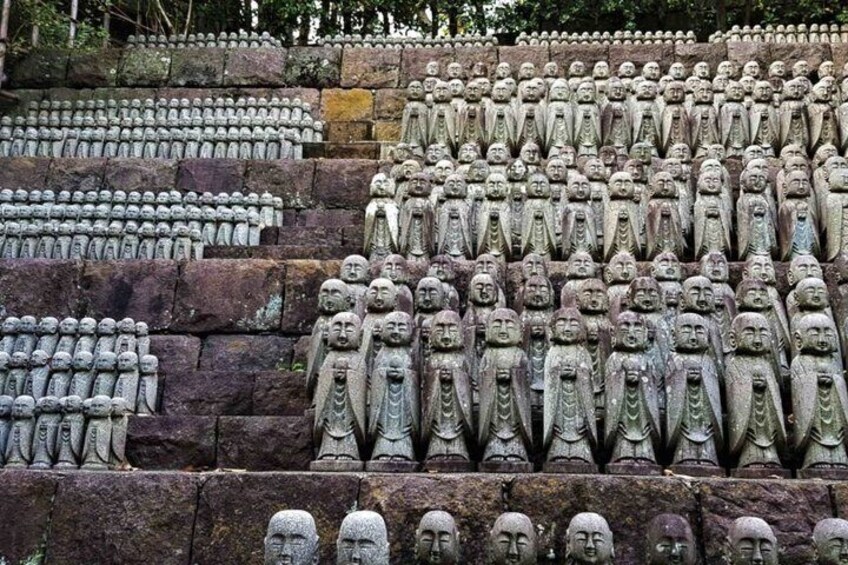 A large number of stone statues arranged in tiers. 5