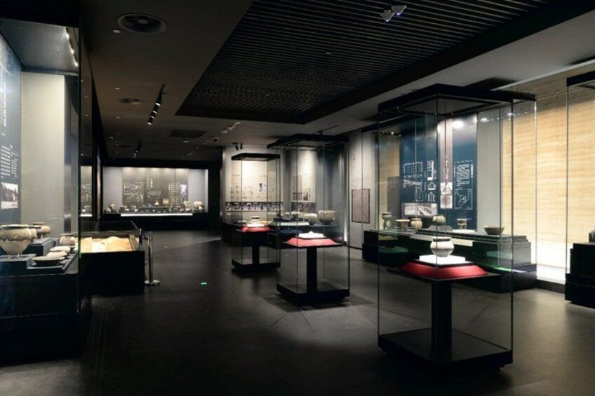 An indoor museum with glass display cases containing artifacts. 2
