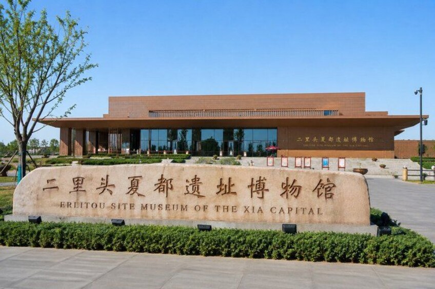 A modern building with a large sign in front. 4