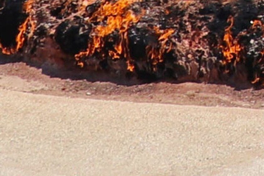 A fire burning on a rocky surface. 2