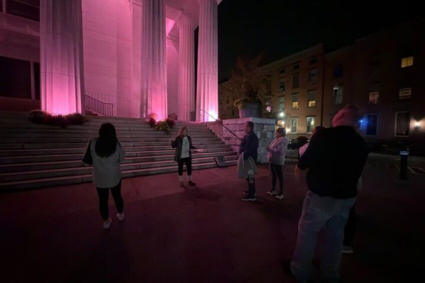 A building with large columns and steps at night, illuminated by pink lighting. 3