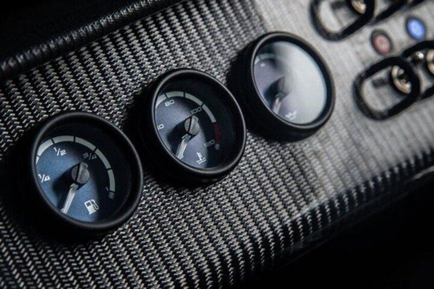 A car's dashboard with three gauges, including a speedometer and tachometer. 3