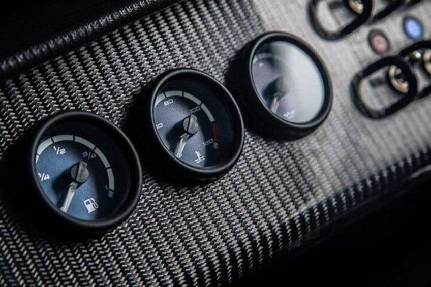 A car's dashboard with three gauges, including a speedometer and tachometer. 3