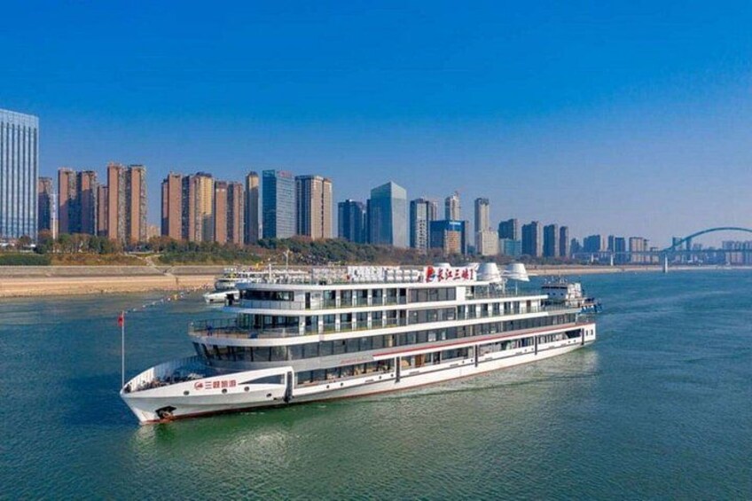 A river cruise ship with a city skyline in the background. 5