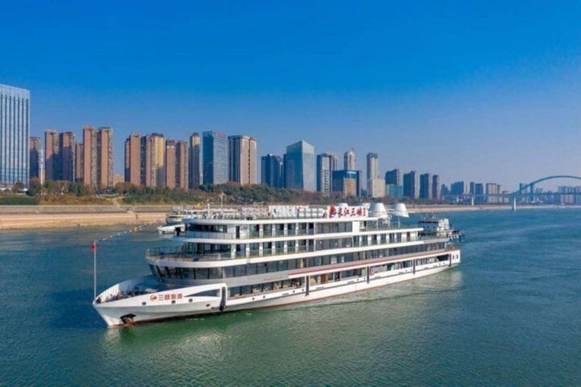 A river cruise ship with a city skyline in the background. 5