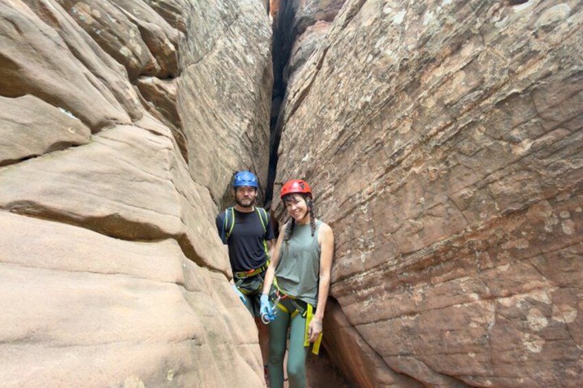 Two people in a canyon with rock walls. 4