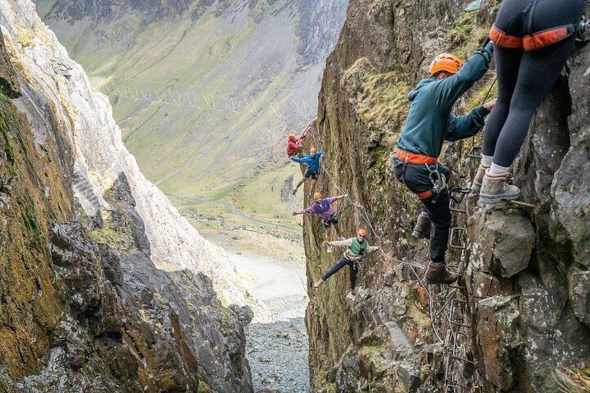 Climbers scaling a steep mountain cliff. 4