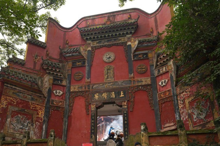 A traditional red gate with intricate carvings and Chinese characters. 4