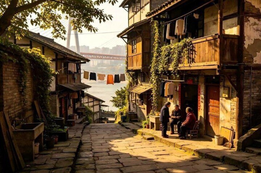 A narrow cobblestone street with buildings on either side, a bridge in the background, and laundry hanging from a line. 3