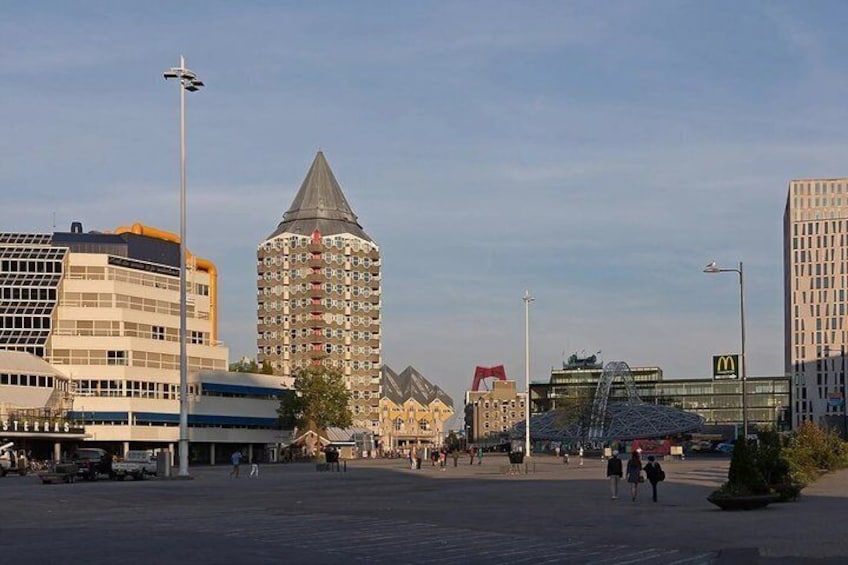 A city square with modern buildings, a tall tower, and a McDonald's restaurant. 5