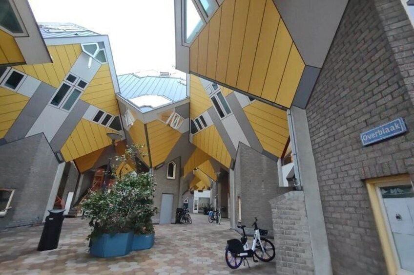 A courtyard with a unique architectural design, featuring geometric patterns and a mix of brick and modern materials. 4