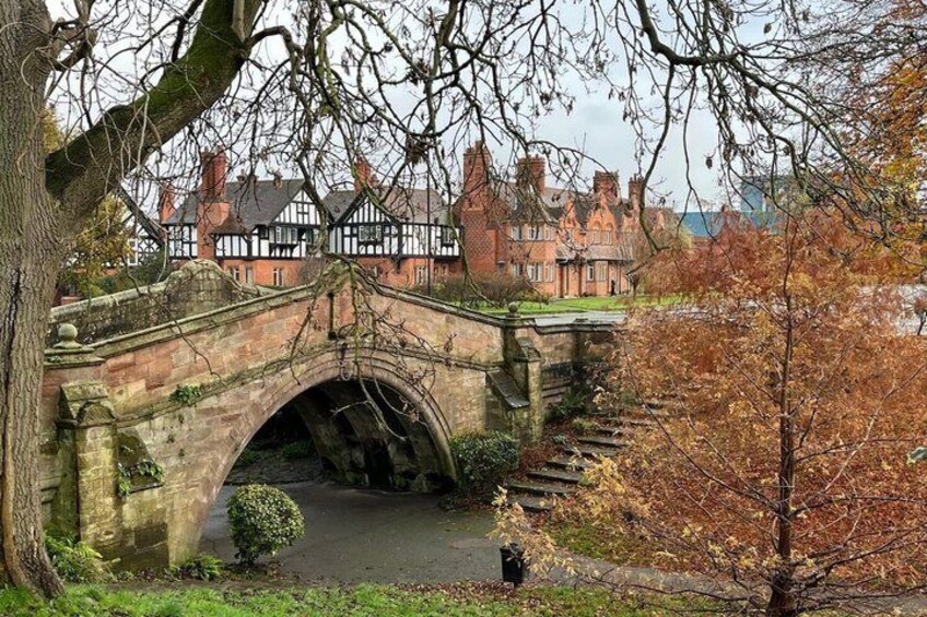 A stone bridge, a historic building, and autumn foliage. 1