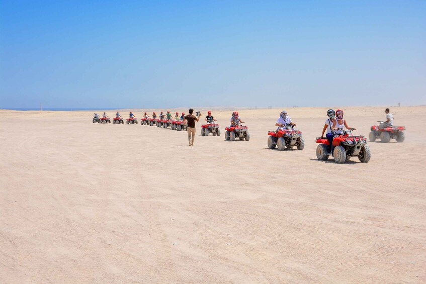 A group of people on ATVs in a desert landscape. 2