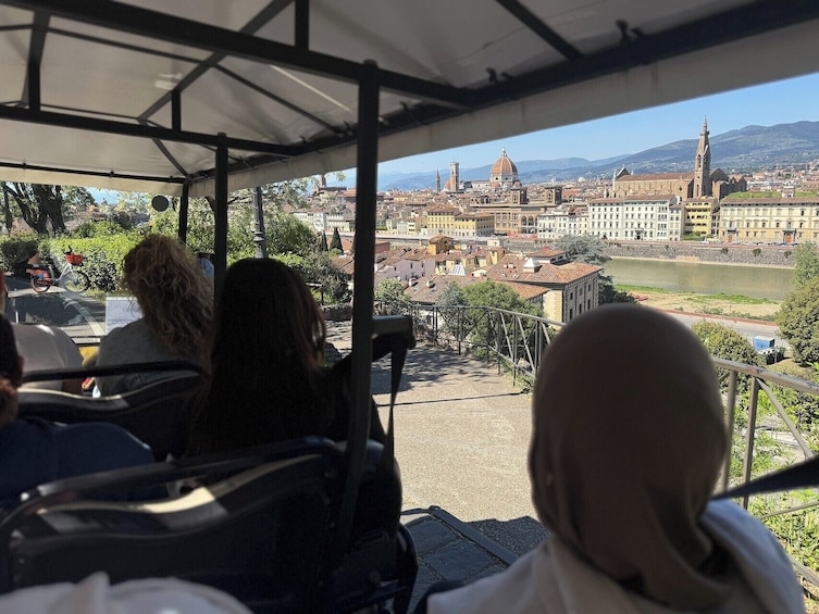 A covered viewing area overlooking a cityscape with historical buildings and a river. 5