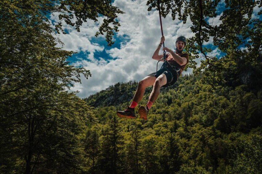 A person zip-lining through a forested area. 3