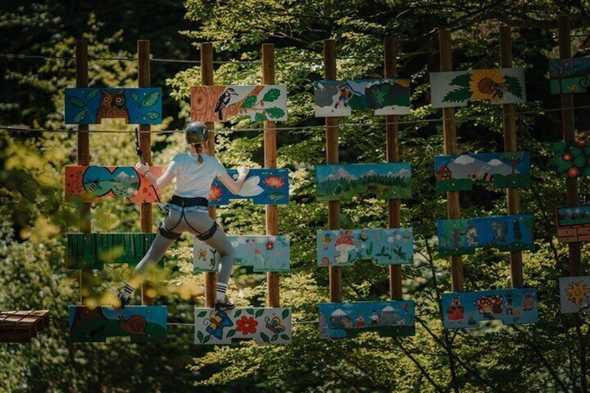 A person navigating an obstacle course with colorful, hand-painted signs. 1