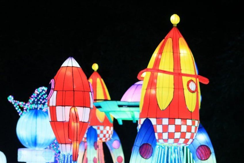 Colorful illuminated structures resembling rockets. 5
