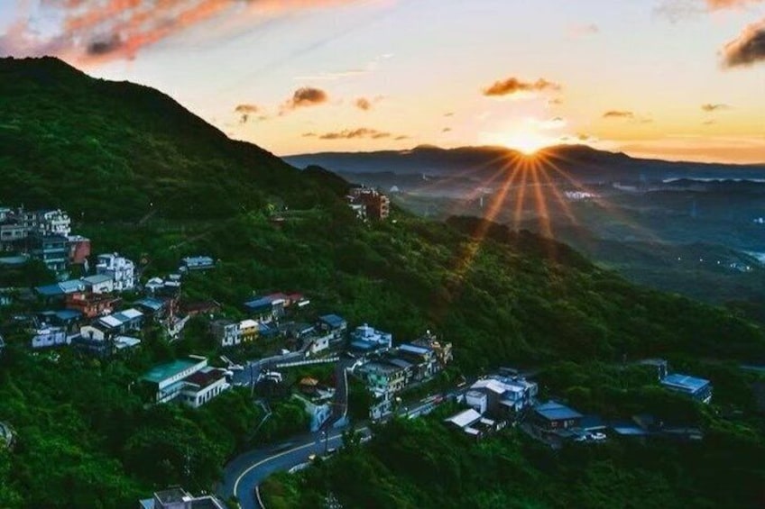A mountainous landscape with a village at sunset. 3
